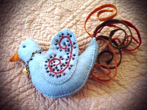 Felt bird with embroidered and beaded wings